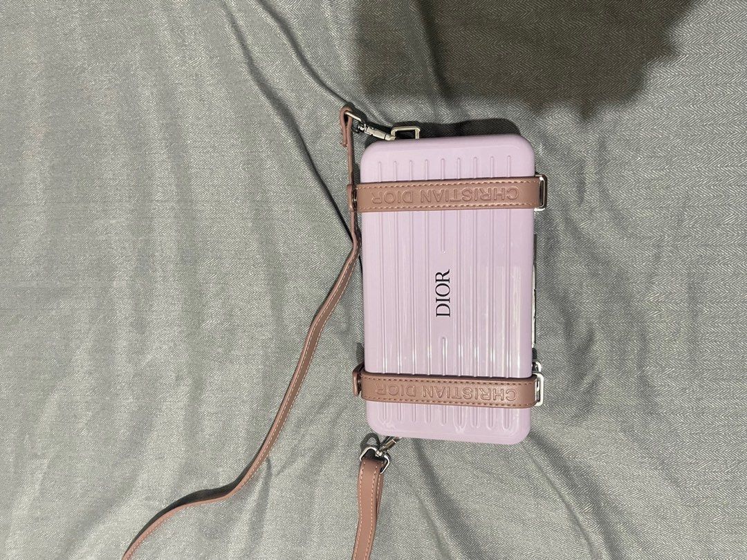 Dior Rimowa Style Handbag with Strap (Category: Luxury Bags & Wallets) located in Manila. Submitted by dyvmx949t543465 (Listing ID 1400680563, Image 2). Description: - Rimowa-inspired handbag - Light purple exterior with matching strap - Dior logo on the front - Zippered compartment inside - Multiple card slots.