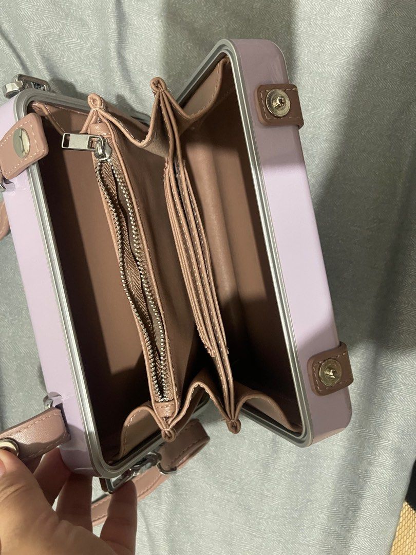 Dior Rimowa Style Handbag with Strap (Category: Luxury Bags & Wallets) located in Manila. Submitted by dyvmx949t543465 (Listing ID 1400680563, Image 3). Description: - Rimowa-inspired handbag - Light purple exterior with matching strap - Dior logo on the front - Zippered compartment inside - Multiple card slots.