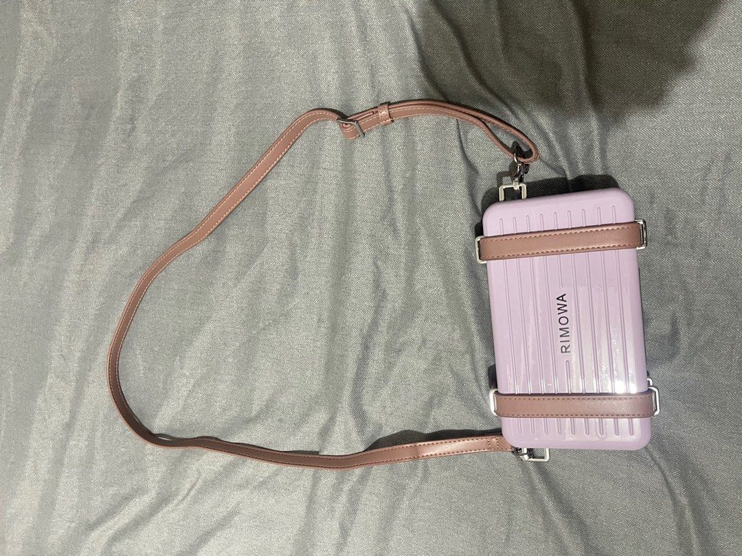 Dior Rimowa Style Handbag with Strap (Category: Luxury Bags & Wallets) located in Manila. Submitted by dyvmx949t543465 (Listing ID 1400680563, Image 1). Description: - Rimowa-inspired handbag - Light purple exterior with matching strap - Dior logo on the front - Zippered compartment inside - Multiple card slots.