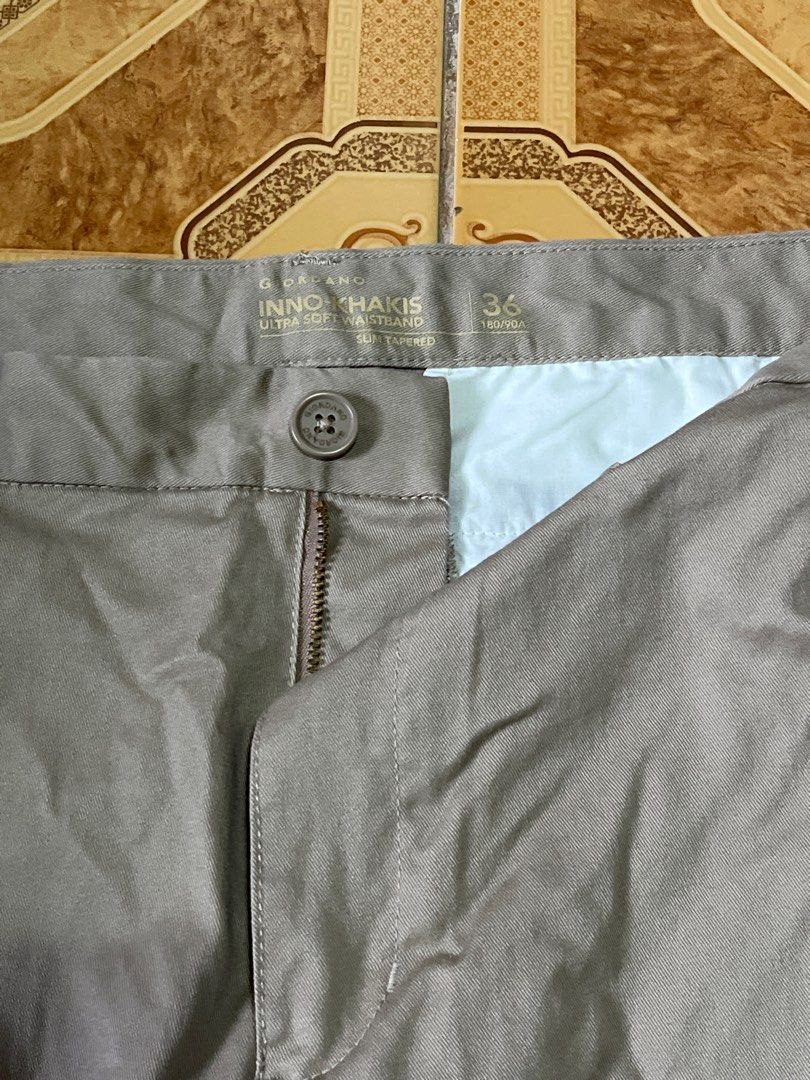Giordano Innov Khakis Pants - Size 36 (Category: Jeans) located in Manila. Submitted by kali_11 (Listing ID 1400674468, Image 2). Description: Giordano Innov Khakis pants in size 36. These pants are a neutral color, suitable for various outfits. They feature a button and zipper closure. The pants have a classic, straight-leg cut. They appear to be made of a soft material. The pants have pockets on the front and back..