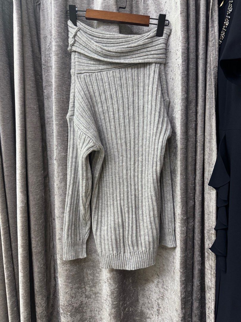 Gray Ribbed Off-Shoulder Knitted Sweater (a bit thick) (Category: Longsleeves) located in Manila. Submitted by qualitylovedph (Listing ID 1400678150, Image 2). Description: - Gray off-shoulder sweater - Ribbed design - Long sleeves - Relaxed fit - Made of thick knit material - Suitable for cooler weather - Versatile style.