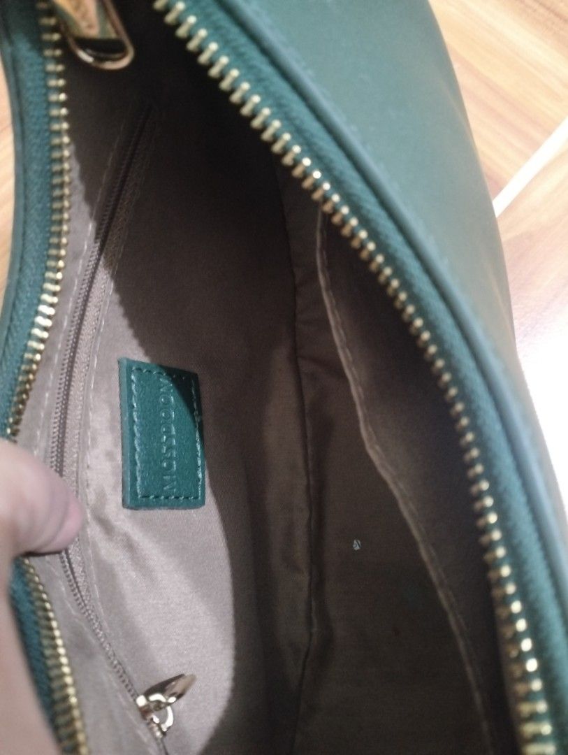 Multisoom Green Shoulder Bag (Category: Luxury Bags & Wallets) located in Manila. Submitted by mysticdolphin-fd4a (Listing ID 1400605035, Image 3). Description: - Brand: Multisoom - Condition: slightly used - Color: Green - Style: Shoulder bag - Shape: Crescent - Closure: Zipper - Strap: Single shoulder strap - Interior: Small pocket - Lining: Light brown - Material: Smooth.