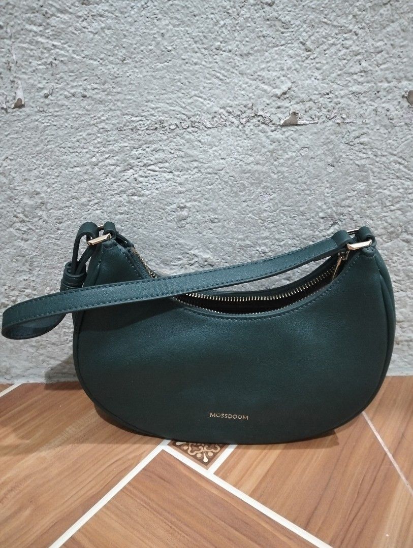 Multisoom Green Shoulder Bag (Category: Luxury Bags & Wallets) located in Manila. Submitted by mysticdolphin-fd4a (Listing ID 1400605035, Image 1). Description: - Brand: Multisoom - Condition: slightly used - Color: Green - Style: Shoulder bag - Shape: Crescent - Closure: Zipper - Strap: Single shoulder strap - Interior: Small pocket - Lining: Light brown - Material: Smooth.