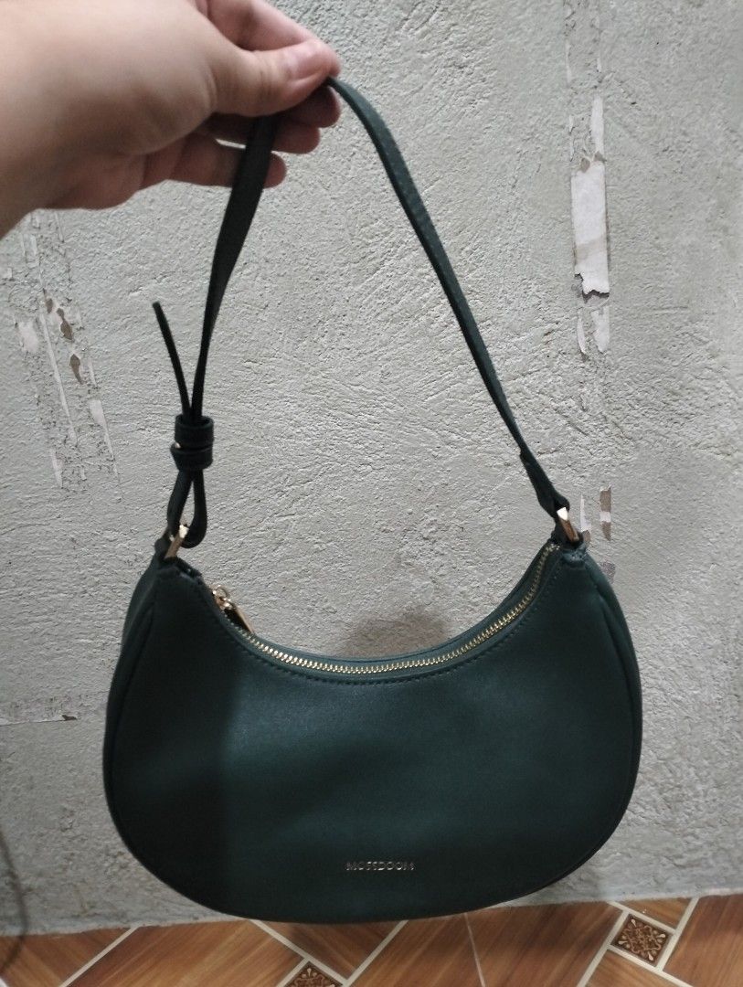 Multisoom Green Shoulder Bag (Category: Luxury Bags & Wallets) located in Manila. Submitted by mysticdolphin-fd4a (Listing ID 1400605035, Image 2). Description: - Brand: Multisoom - Condition: slightly used - Color: Green - Style: Shoulder bag - Shape: Crescent - Closure: Zipper - Strap: Single shoulder strap - Interior: Small pocket - Lining: Light brown - Material: Smooth.