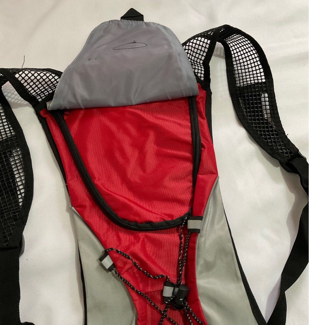 Nanfeng Airflow Hydration Backpack Vest In Red & Grey (No Bladder) (Category: Accessory Holder, Box & Organizers) located in Caloocan City. Submitted by de_clothur (Listing ID 1400589665, Image 3). Description: - condition: 7/10 - kinda old - no more other parts included (no bladder) - holds 2L water - has another pocket for personal items - see ties condition .
