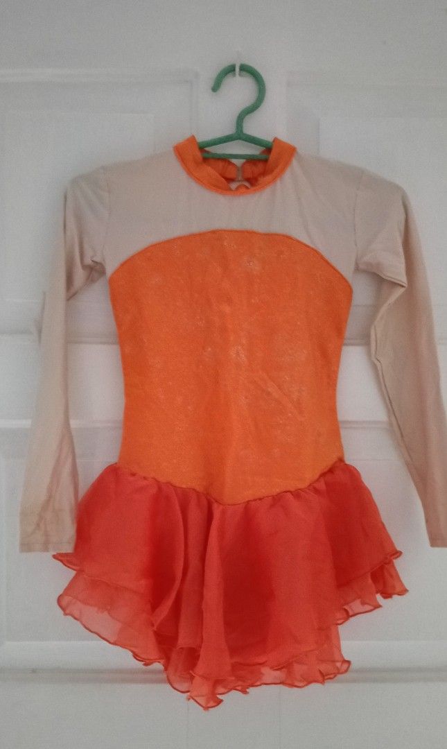 Orange Dance Leotard / figure skating dress (Category: Babies & Kids Fashion) located in Paranaque City. Submitted by yesyesyo (Listing ID 1400640677, Image 1). Description: Dance leotard features a vibrant orange bodice and skirt, complemented by beige sleeves and upper back. It has a keyhole back design and a high neckline. The skirt is layered with a flowing, ruffled effect. waist when laid flat: 10" length: 22" stretchchable tailored for my d