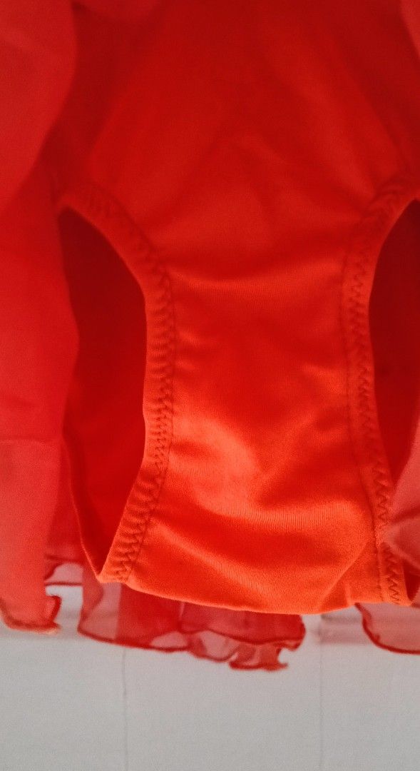 Orange Dance Leotard / figure skating dress (Category: Babies & Kids Fashion) located in Paranaque City. Submitted by yesyesyo (Listing ID 1400640677, Image 3). Description: Dance leotard features a vibrant orange bodice and skirt, complemented by beige sleeves and upper back. It has a keyhole back design and a high neckline. The skirt is layered with a flowing, ruffled effect. waist when laid flat: 10" length: 22" stretchchable tailored for my d
