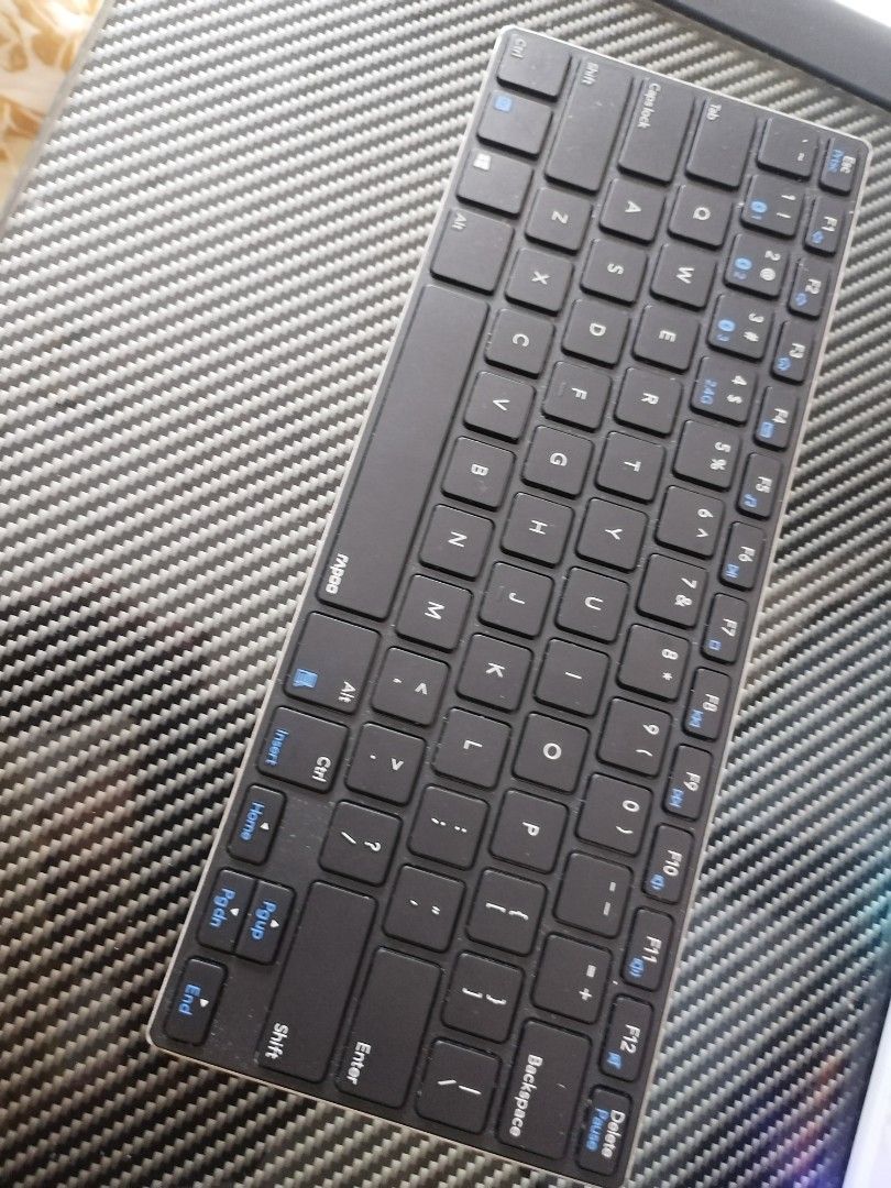Rapoo Ultra-Slim Wireless Keyboard (Category: Computer Keyboard) located in Paranaque City. Submitted by umimariel02 (Listing ID 1400725663, Image 1). Description: RFS. Di nagagamit. sayang😑 - Rapoo ultra-slim wireless keyboard - Black key layout with blue function keys - Silver back and slim profile - Compact design - Suitable for various uses.