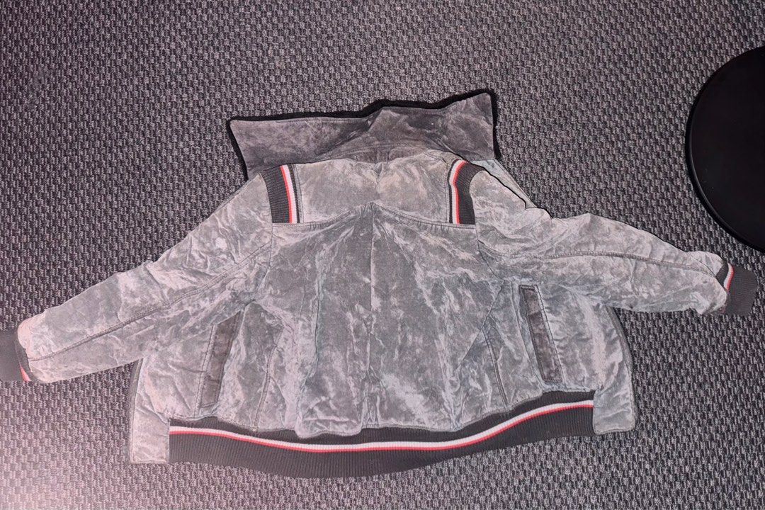 Suede Grey Faux Fur Bomber Jacket (Category: Coats, Jackets and Outerwear) located in Manila. Submitted by khloset (Listing ID 1400678040, Image 3). Description: Perfect for winter - - Grey jacket features a faux fur lining and collar for added warmth. It has a ribbed hem and cuffs with red and white stripes. The jacket has a zip closure and two front pockets..