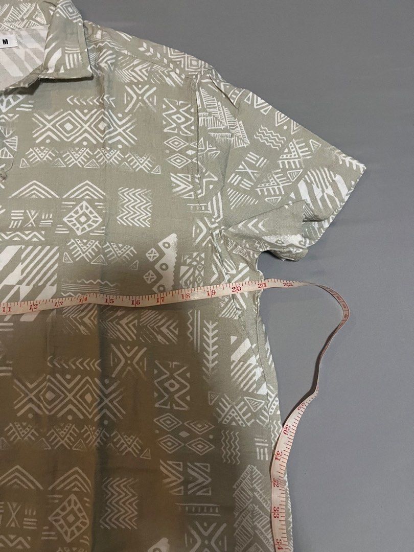 Terranova Printed Short Sleeve Shirt (Category: Tshirts & Polo Shirts ) located in Tarlac. Submitted by johnjohnjohn23 (Listing ID 1400647676, Image 3). Description: - Terranova short sleeve shirt - Unique printed design - Collared neckline - Button-down closure - Neutral color with white geometric patterns - Size: Medium - Measurements in images - Perfect for casual wear.