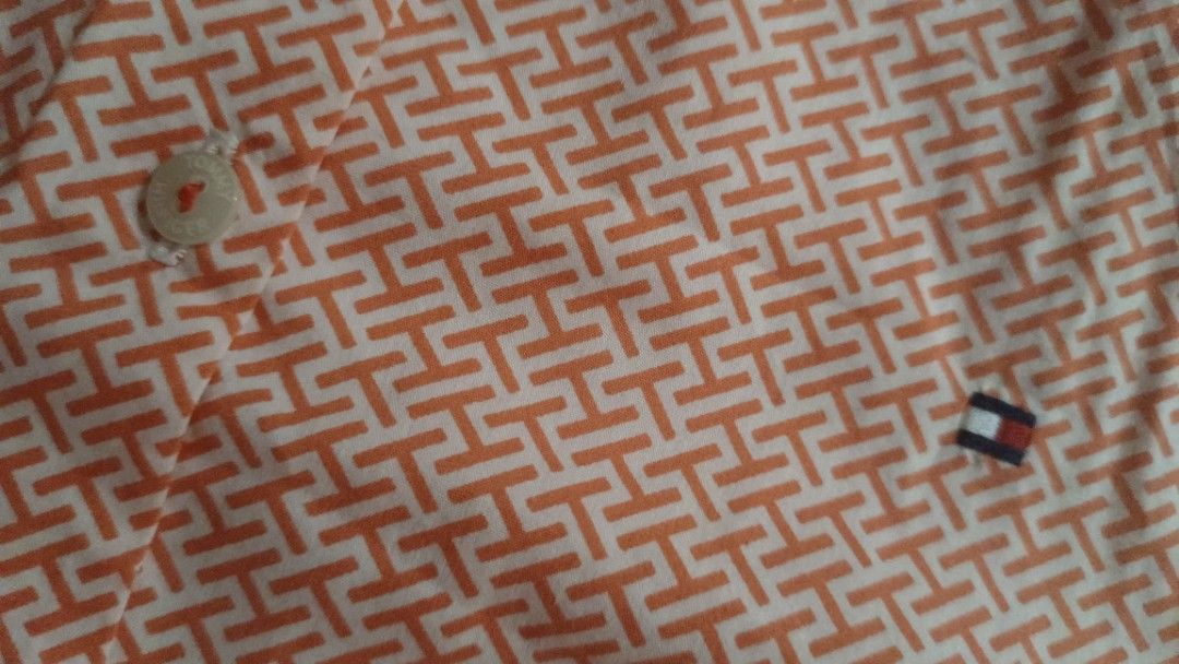 Tommy Hilfiger Slim Fit polo blouse (Category: Blouses) located in Muntinlupa City. Submitted by amara211629 (Listing ID 1400639976, Image 3). Description: - Tommy Hilfiger short-sleeved shirt - Vibrant orange color - Size 4, slim fit - Button-down front cotton - Collared neckline - Stylish geometric pattern - Features the Tommy Hilfiger logo * M- Semi Large RFS: I'm M but shoulder width is too long for me. .