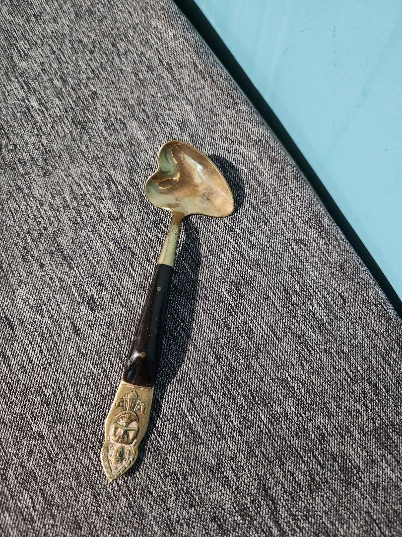 Vintage Brass Spoon with Ornate Handle (Category: Dinnerware & Cutlery) located in Baguio. Submitted by alonasteph (Listing ID 1400637962, Image 1). Description: Vintage spoon features a brass bowl and a dark wooden handle with brass accents. The handle has an ornate design at the end. It would be a great addition to a collection or a decorative piece..