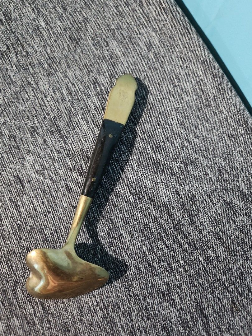 Vintage Brass Spoon with Ornate Handle (Category: Dinnerware & Cutlery) located in Baguio. Submitted by alonasteph (Listing ID 1400637962, Image 2). Description: Vintage spoon features a brass bowl and a dark wooden handle with brass accents. The handle has an ornate design at the end. It would be a great addition to a collection or a decorative piece..