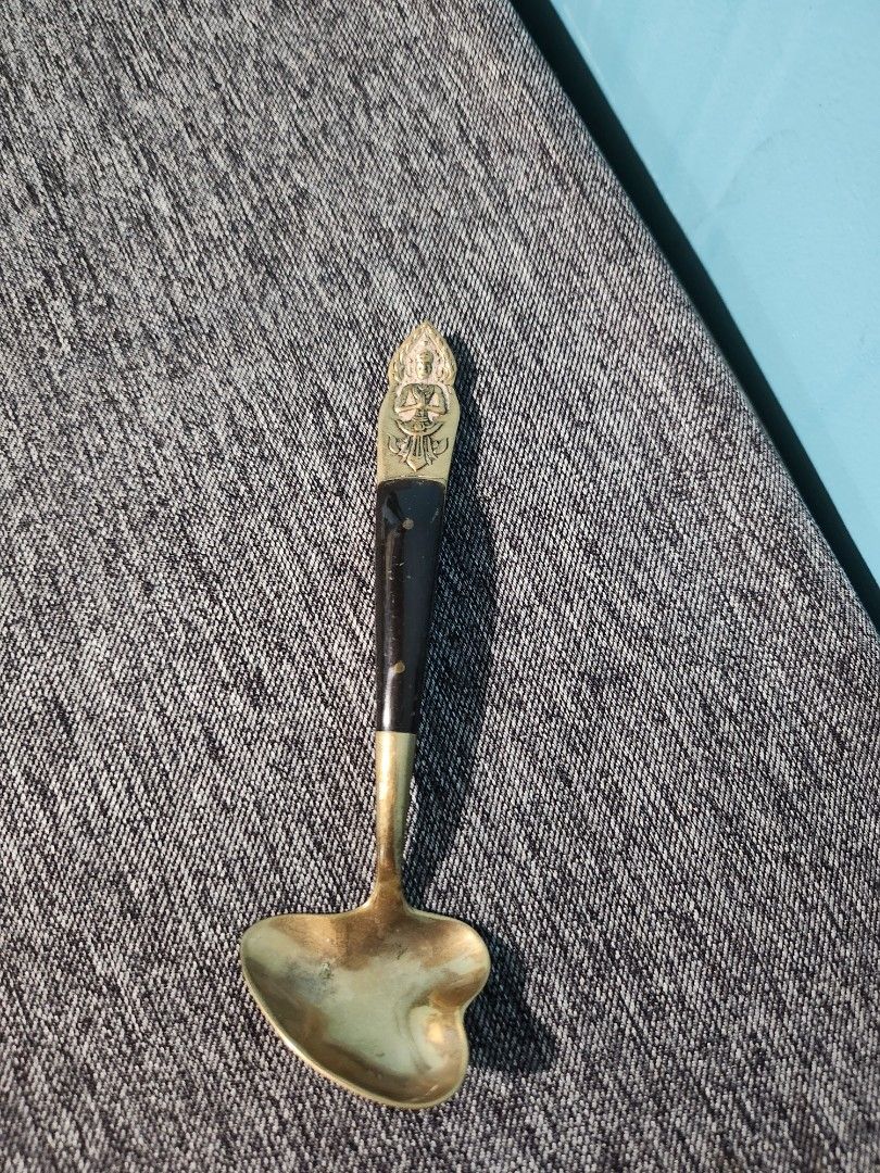 Vintage Brass Spoon with Ornate Handle (Category: Dinnerware & Cutlery) located in Baguio. Submitted by alonasteph (Listing ID 1400637962, Image 3). Description: Vintage spoon features a brass bowl and a dark wooden handle with brass accents. The handle has an ornate design at the end. It would be a great addition to a collection or a decorative piece..