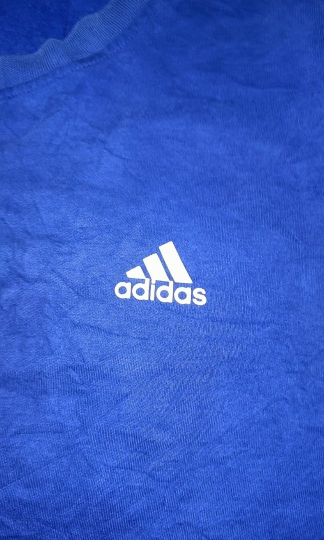 ADIDAS BLUE SWEATSHIRT XL (Category: Coats, Jackets and Outerwear) located in Lucban. Submitted by goodsheetcollection (Listing ID 1400970256, Image 2). Description: - Adidas blue sweatshirt - Size: XL (Measurements: 28x22) - Features Adidas logo on chest - Small patch on left sleeve - Crew neck - Long sleeves - Made of soft, textured material.