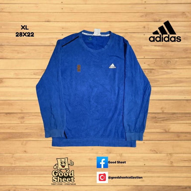 ADIDAS BLUE SWEATSHIRT XL (Category: Coats, Jackets and Outerwear) located in Lucban. Submitted by goodsheetcollection (Listing ID 1400970256, Image 1). Description: - Adidas blue sweatshirt - Size: XL (Measurements: 28x22) - Features Adidas logo on chest - Small patch on left sleeve - Crew neck - Long sleeves - Made of soft, textured material.