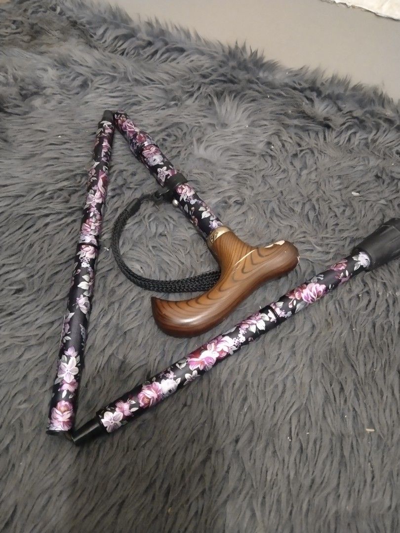 Affordable foldable walking cane/stick 😍👌 (Category: Medical Supplies & Tools) located in Malolos. Submitted by afford.japan (Listing ID 1400926622, Image 1). Description: - Floral design on a black background - Wooden handle - Includes wrist strap - Folds for easy storage and transport - Rubber tip for stability - Stylish and practical mobility aid.