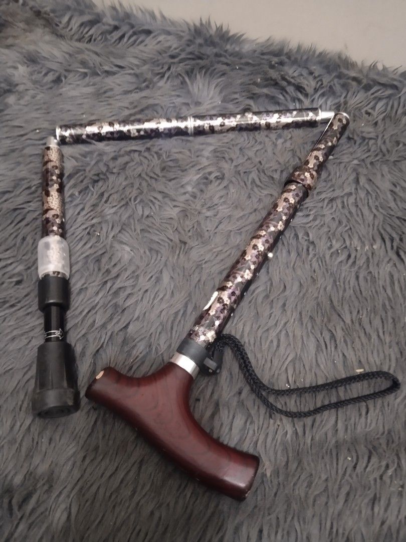 Affordable foldable walking cane/stick A😍👌 (Category: Medical Supplies & Tools) located in Malolos. Submitted by afford.japan (Listing ID 1400927511, Image 1). Description: - Adjustable walking cane - Patterned shaft - Comfortable wooden handle - Includes wrist strap - Foldable design - Rubber tip for stability - Dark brown handle finish.