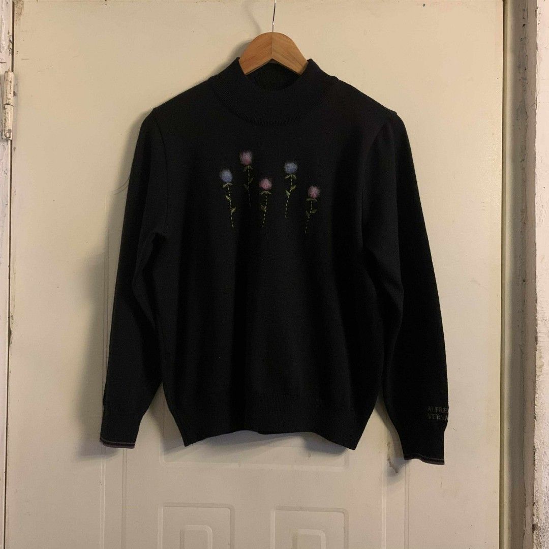 Alfredo Versace Floral Embroidered Sweater (Category: Coats, Jackets and Outerwear) located in Carmen. Submitted by don-lean22 (Listing ID 1400924712, Image 1). Description: Black sweater Mock neck Long sleeves Embroidered floral design on front "Alfredo Versace" embroidered on sleeve Size 100 Pristine condition.