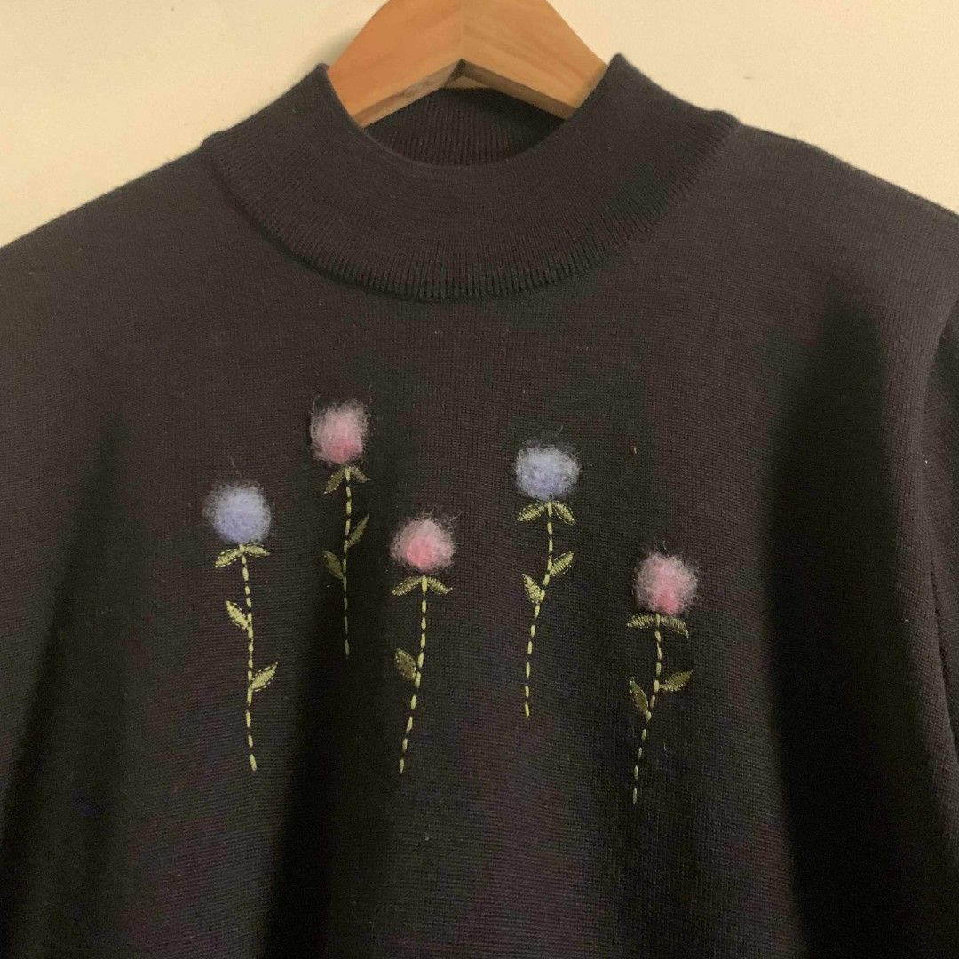 Alfredo Versace Floral Embroidered Sweater (Category: Coats, Jackets and Outerwear) located in Carmen. Submitted by don-lean22 (Listing ID 1400924712, Image 2). Description: Black sweater Mock neck Long sleeves Embroidered floral design on front "Alfredo Versace" embroidered on sleeve Size 100 Pristine condition.