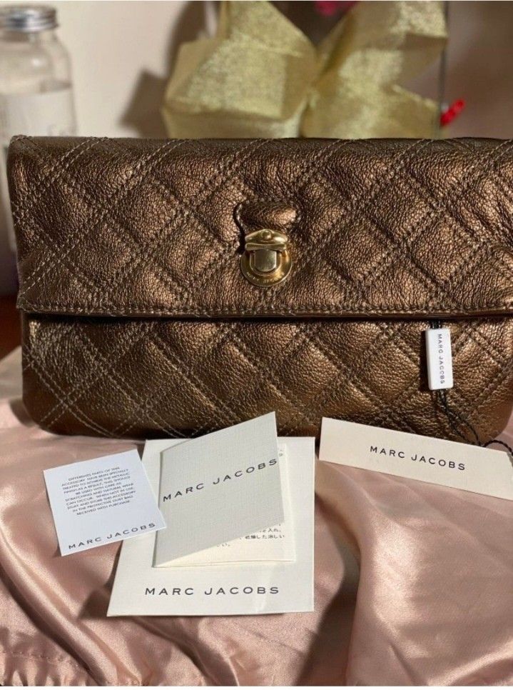 💯Authentic Marc Jacobs Gold Eugenie Clutch Wallet (Category: Luxury Bags & Wallets) located in Tagum. Submitted by maryjanepradalux (Listing ID 1400790854, Image 1). Description: *with card&Dustbag *No Issue *No flaws *Brandnew *Money Back Guarantee if proven fake *Bought from singapore *Pm for more details *MARC JACOBS.