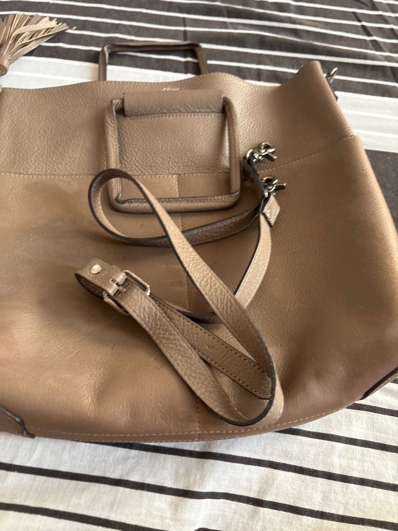 Celine Tote Bag with Shoulder Strap (Category: Luxury Bags & Wallets) located in Las Pinas. Submitted by ochey20 (Listing ID 1400831433, Image 2). Description: -Authentic celine bag -Celine tote bag in taupe - Top handle and detachable shoulder strap - Decorative tassels - Magnetic closure - Burgundy interior lining - Structured design - Pebbled leather texture.