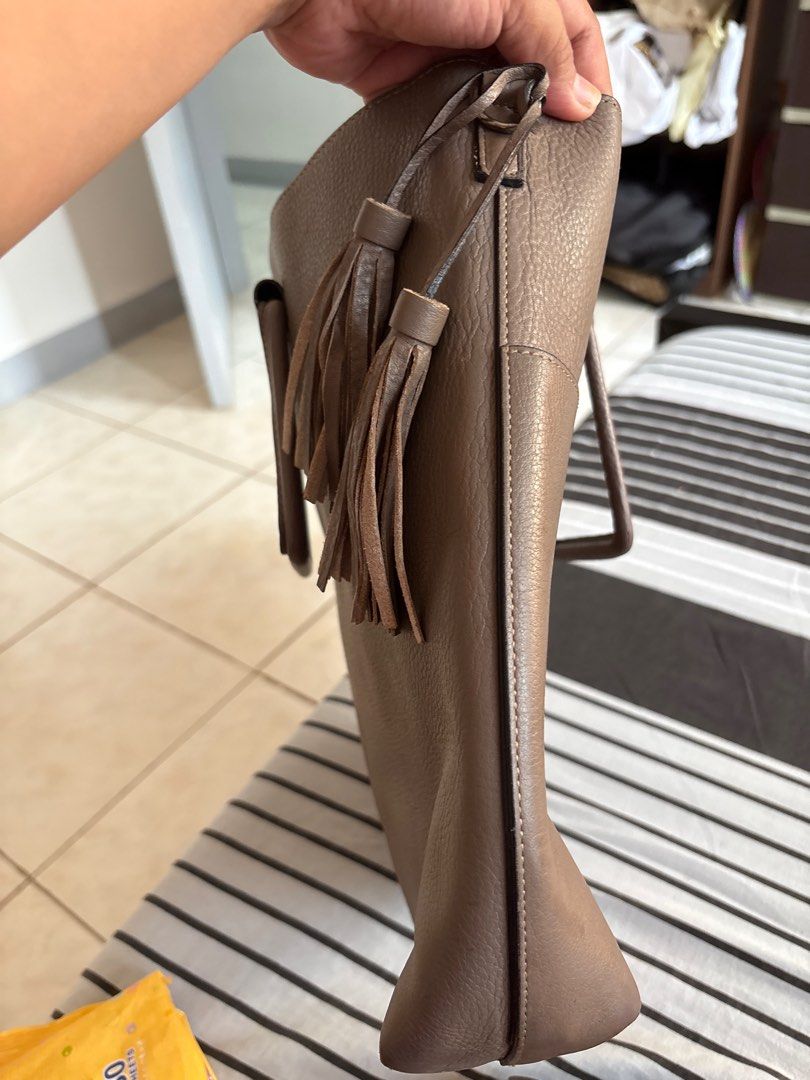 Celine Tote Bag with Shoulder Strap (Category: Luxury Bags & Wallets) located in Las Pinas. Submitted by ochey20 (Listing ID 1400831433, Image 3). Description: -Authentic celine bag -Celine tote bag in taupe - Top handle and detachable shoulder strap - Decorative tassels - Magnetic closure - Burgundy interior lining - Structured design - Pebbled leather texture.
