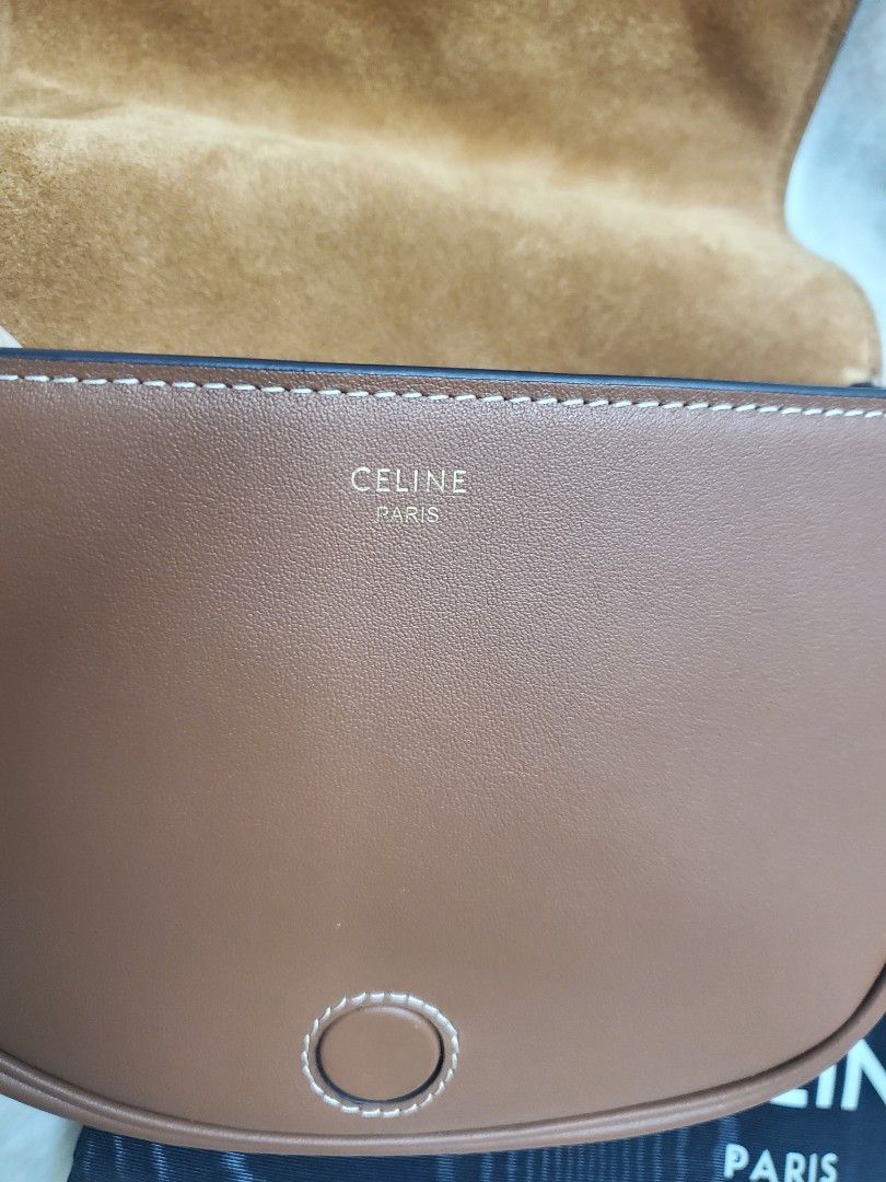 Celine Triomphe Shoulder Bag (Category: Luxury Bags & Wallets) located in Manila. Submitted by mavel0817 (Listing ID 1400827842, Image 2). Description: - Celine Triomphe shoulder bag - Color: Brown - Leather interior lining - Includes dust bag - Stitched design - Celine brand name visible inside.