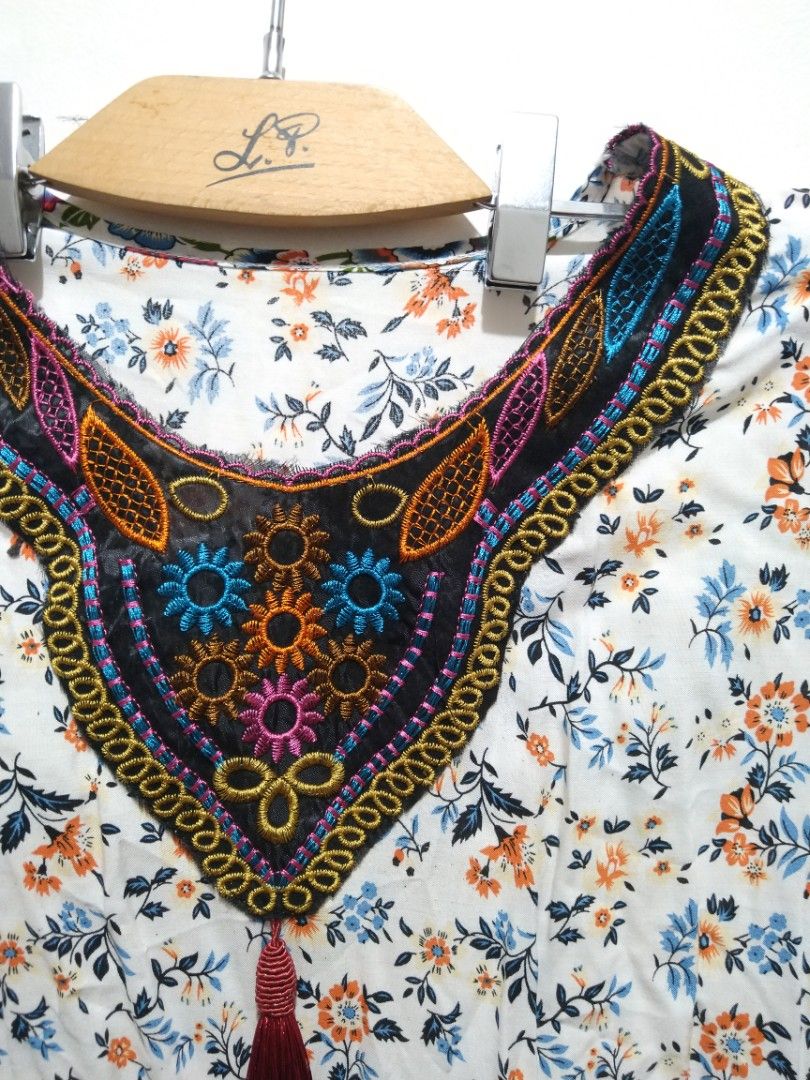 Challis Floral White Dress (Category: Dresses) located in Rizal. Submitted by rmrkshmc (Listing ID 1400875047, Image 3). Description: - Bohemian floral print dress - bust: 20" laid flat - length: 36" - Mid-lengrh sleeves - lightweight challis fabric - Detailed embroidered neckline with tassel - needs washing - Ideal for casual wear, beach outings, or relaxed days out - mop: gcash - loc: Mayamot, Antipolo .