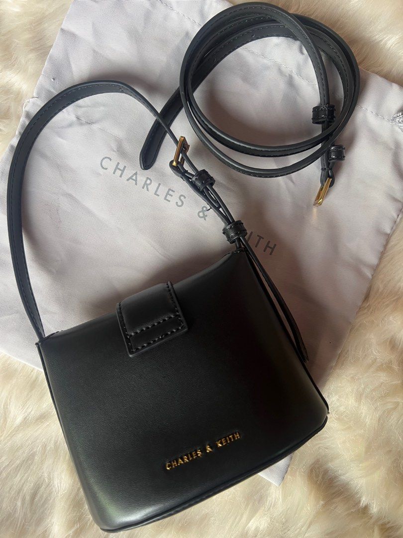 Charles & Keith Gabine Bucket Bag - Black (Category: Shoulder Bags) located in Taguig. Submitted by ljred23 (Listing ID 1400965133, Image 3). Description: Can fit small wallet or card holder. Lipstick, mirror and small cosmetic pouch. Mint condition. 2 way bag and comes with dust bag. .