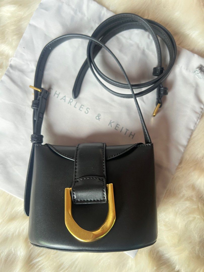 Charles & Keith Gabine Bucket Bag - Black (Category: Shoulder Bags) located in Taguig. Submitted by ljred23 (Listing ID 1400965133, Image 2). Description: Can fit small wallet or card holder. Lipstick, mirror and small cosmetic pouch. Mint condition. 2 way bag and comes with dust bag. .