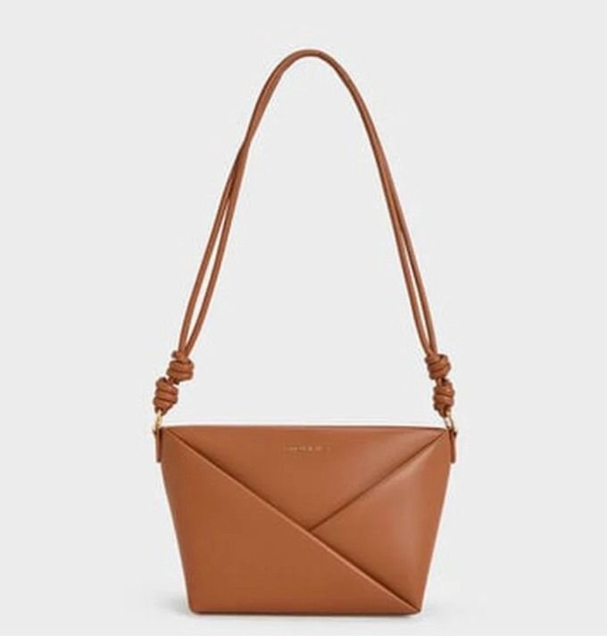 Charles & Keith Tan Crossbody Bag (Category: Cross-body Bags) located in Makati City. Submitted by masaca (Listing ID 1397536995, Image 1). Description: - Charles & Keith crossbody bag - Color: Tan - Unique envelope design with white accent - Features a zip closure - Includes a long strap - Size: S - Brand new with original tags.