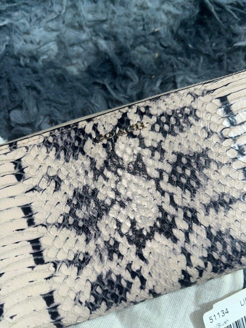 Coach Madison Two Tone Python Wallet Model 51134 (Category: Luxury Bags & Wallets) located in Angeles City. Submitted by declutterko (Listing ID 1400960330, Image 2). Description: - Authentic Coach wallet - Unique snakeskin pattern - Zip-around closure - Multiple card slots - Light pink interior - Includes original dust bag and care instructions - Model: 51134 - Color: LI/Blush ‼️With minor stains (see the last 2 pics).