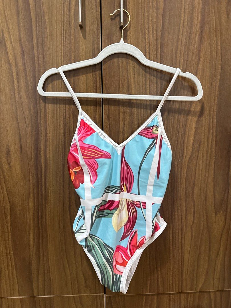 Floral Print Swimsuit (Category: Bikinis & Swimsuits) located in Manila. Submitted by mingmingtsu_ (Listing ID 1400889232, Image 1). Description: - Floral print one-piece swimsuit - Light blue background with white trim - V-neck design - Spaghetti straps - Floral pattern on the back.