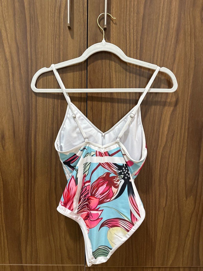 Floral Print Swimsuit (Category: Bikinis & Swimsuits) located in Manila. Submitted by mingmingtsu_ (Listing ID 1400889232, Image 2). Description: - Floral print one-piece swimsuit - Light blue background with white trim - V-neck design - Spaghetti straps - Floral pattern on the back.