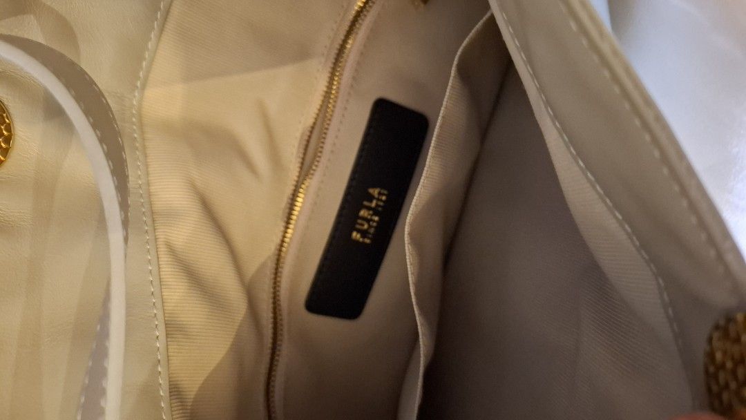 Furla SFERA Shoulder Bag (Category: Luxury Bags & Wallets) located in Taguig. Submitted by melishlove (Listing ID 1400873071, Image 3). Description: - Authentic Furla shoulder bag - Unique design with gold-tone accent - Detachable strap included - Spacious interior - Comes with original tag (model & price) - Includes dust bag - Features Furla interior label.
