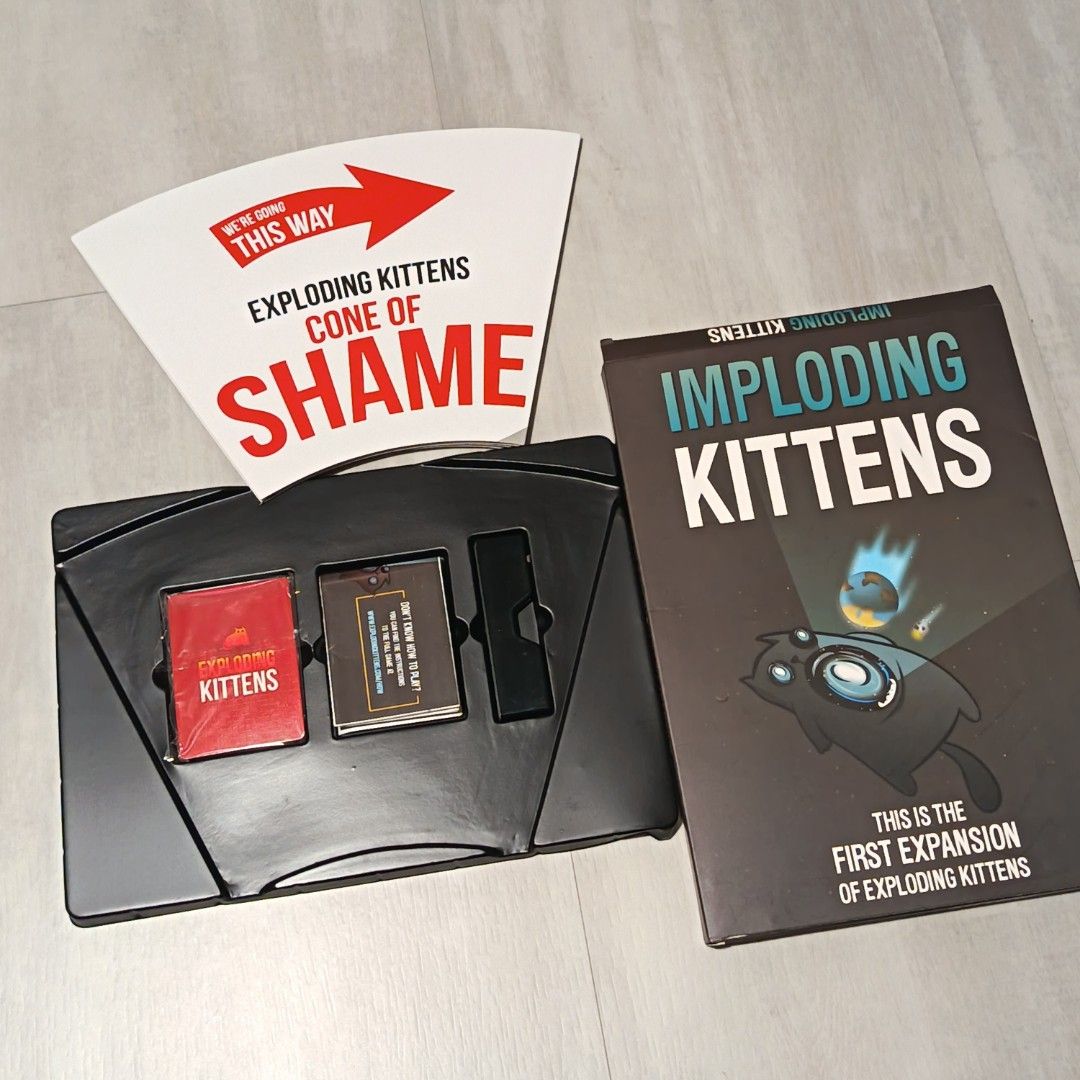 Imploding Kittens Expansion Pack for Exploding Kittens (Category: Board Games & Puzzles) located in Singapore. Submitted by hello.gdbuy (Listing ID 1400783671, Image 1). Description: - Imploding Kittens expansion pack for Exploding Kittens. - Includes the "Cone of Shame". - First expansion pack. - Ideal for game nights and fun with friends!.