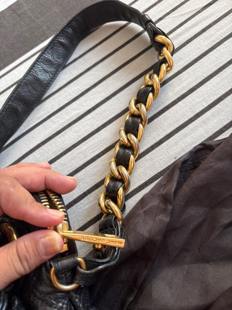 Marc Jacobs Black Quilted Handbag (Category: Luxury Bags & Wallets) located in Las Pinas. Submitted by ochey20 (Listing ID 1400829629, Image 3). Description: - Authentic Marc Jacobs handbag - Black quilted design - Gold-tone chain straps and hardware - Top handle - Zip closure - Fabric-lined interior with zip pocket - Unique gathered detailing - dust bag not included.