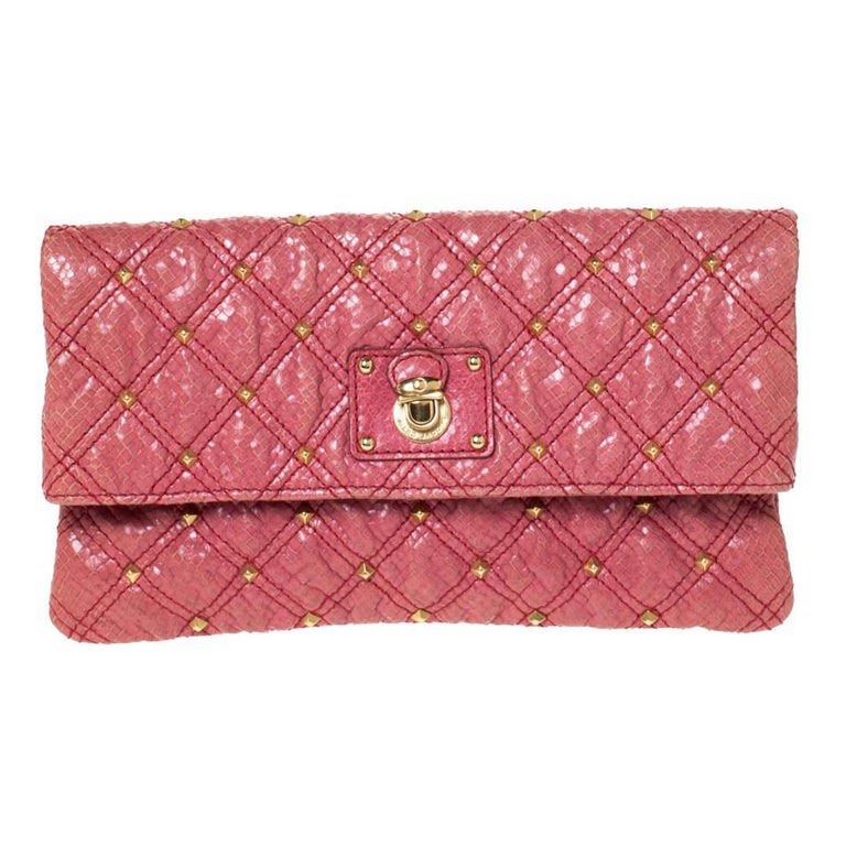 Marc Jacobs Quilted Clutch (Category: Luxury Bags & Wallets) located in Manila. Submitted by o_authentique (Listing ID 1400966116, Image 1). Description: - Authentic Marc Jacobs clutch - Quilted design - Gold-tone stud details - Fold-over flap with turn-lock closure - Chic pink color - Stylish accessory.
