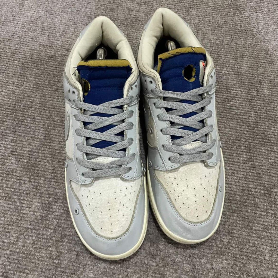 Nike Dunk Low Off-White Lot 49 (Category: Sneakers) located in Davao. Submitted by connected082 (Listing ID 1400944573, Image 3). Description: 11 US / 29 CM Nike Dunk Low Off-White Lot 49. Features a light grey and cream colorway with blue accents. The shoes have the Nike logo on the side and the heel. The size tag is visible in one of the images. Includes the original box and shoe trees. The soles show minimal wear..