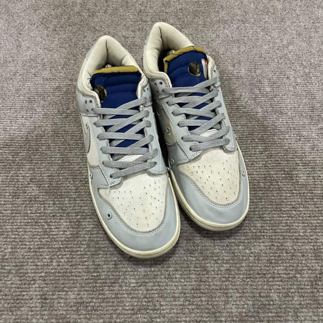 Nike Dunk Low Off-White Lot 49 (Category: Sneakers) located in Davao. Submitted by connected082 (Listing ID 1400944573, Image 2). Description: 11 US / 29 CM Nike Dunk Low Off-White Lot 49. Features a light grey and cream colorway with blue accents. The shoes have the Nike logo on the side and the heel. The size tag is visible in one of the images. Includes the original box and shoe trees. The soles show minimal wear..
