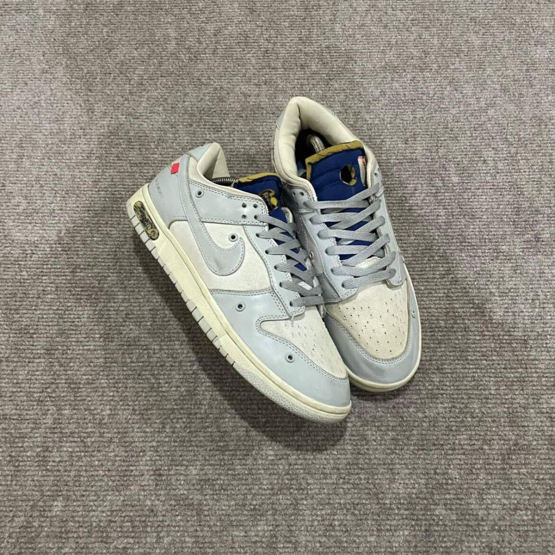 Nike Dunk Low Off-White Lot 49 (Category: Sneakers) located in Davao. Submitted by connected082 (Listing ID 1400944573, Image 1). Description: 11 US / 29 CM Nike Dunk Low Off-White Lot 49. Features a light grey and cream colorway with blue accents. The shoes have the Nike logo on the side and the heel. The size tag is visible in one of the images. Includes the original box and shoe trees. The soles show minimal wear..