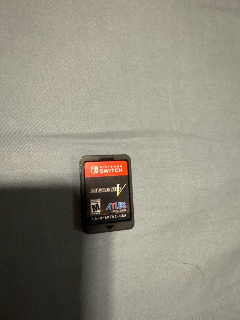 Shin Megami Tensei V - Nintendo Switch Game (with case) (Category: Nintendo) located in Manila. Submitted by andr29951 (Listing ID 1400965685, Image 1). Description: - Shin Megami Tensei V game cartridge for Nintendo Switch. - Features the Atlus logo. - Rated M for Mature. - Black cartridge with red Nintendo Switch logo. - Includes code LA-H-AM7NC-USA..