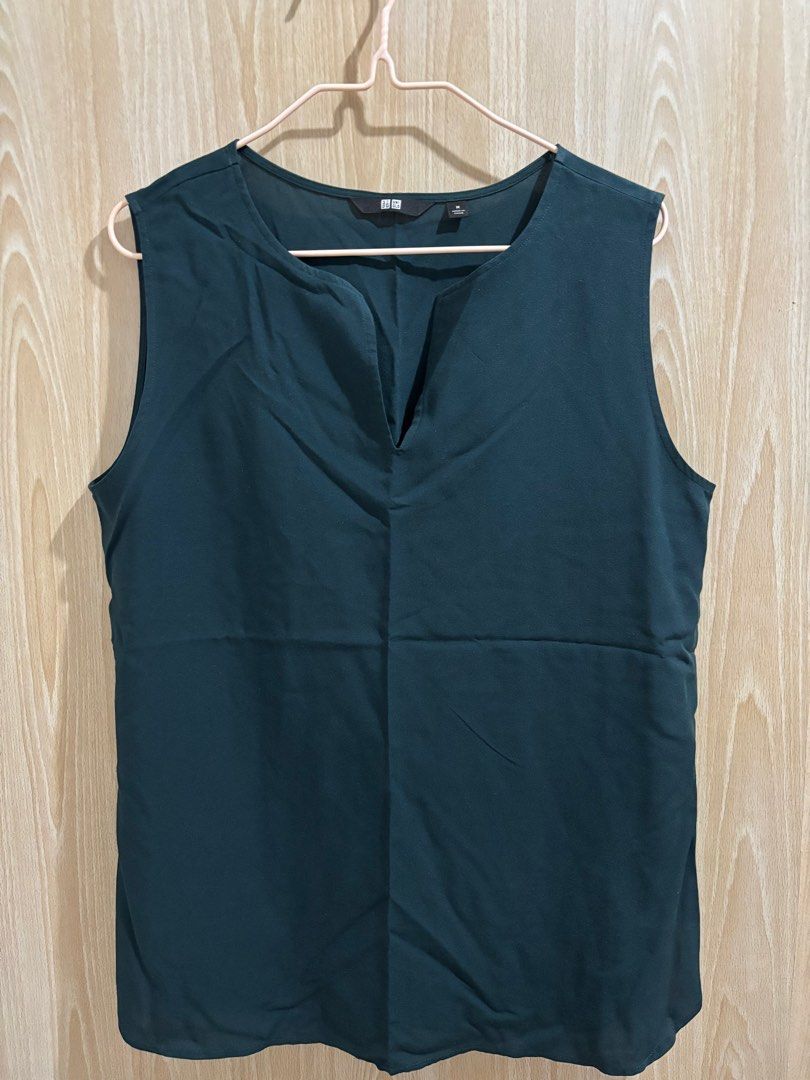 Uniqlo Sleeveless Top Medium (Category: Sleeveless) located in Balanga. Submitted by pmcgee (Listing ID 1400964005, Image 1). Description: - Uniqlo sleeveless top - Size: M - Color: Dark Teal - Design: V-neck - Fabric: Smooth, likely synthetic - Style: Simple, classic - Condition: Good as new.