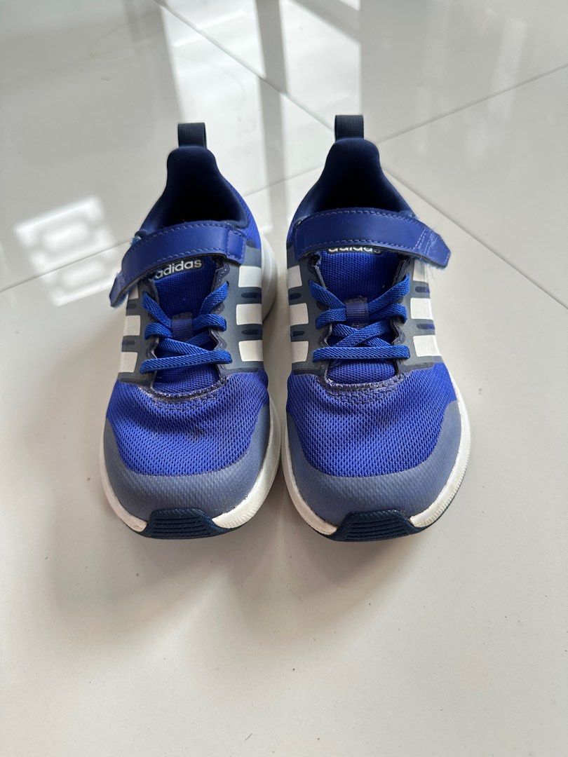 Adidas Kids' Running Shoes (Category: Babies & Kids Fashion) located in Amadeo. Submitted by mafpl (Listing ID 1401018399, Image 1). Description: Size: US 11.5 / UK 11 - Adidas kids' running shoes - Color: Blue and white - Easy on/off with hook-and-loop strap - Breathable mesh upper - Durable white sole - Adidas logo detail.