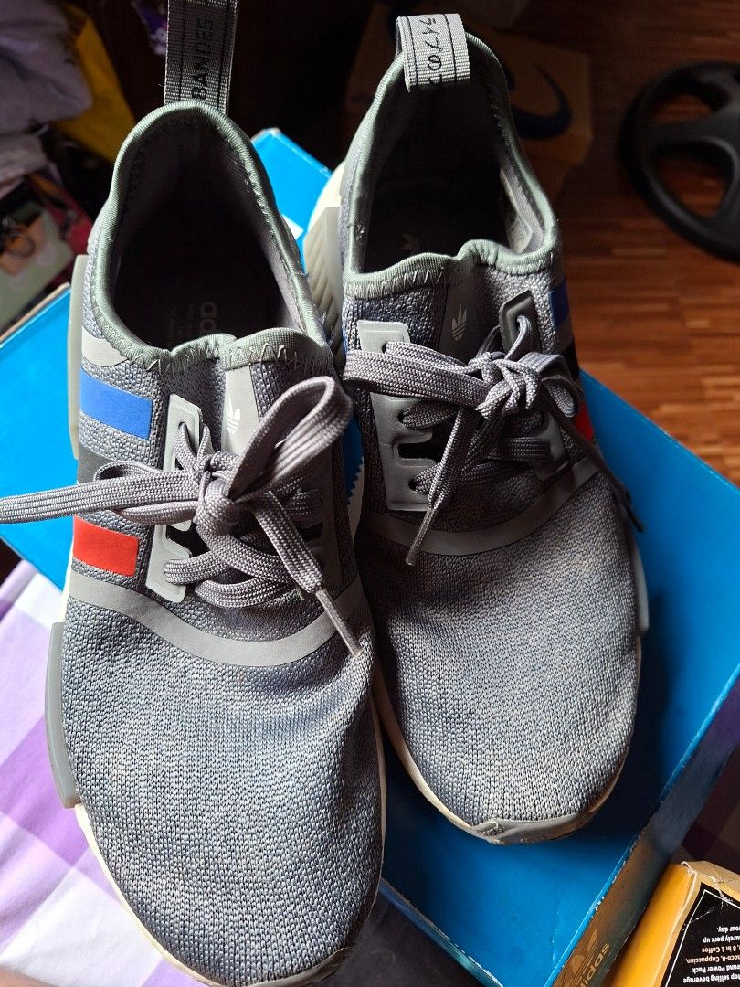 Adidas NMD R1 Grey Sneakers (Category: Sneakers) located in Rizal. Submitted by silverposh (Listing ID 1401026280, Image 1). Description: - Adidas NMD R1 sneakers - Color: Grey with red and blue stripes - White sole - Grey laces - Size:men- US 7 / UK 6 / EU 40 / JP 250 size 8.5 for women - Includes original box used lije 2-3x only.