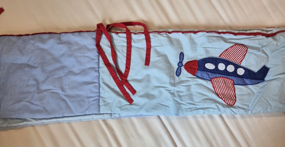 Airplane Crib Bumper (Category: Cots & Cribs) located in Quezon City. Submitted by stmcc (Listing ID 1400999369, Image 2). Description: - Airplane design crib bumper - Light blue background - Red and blue airplane applique - Red trim and ties - Reversible with blue and white checkered pattern Good for 28x52 cribs.