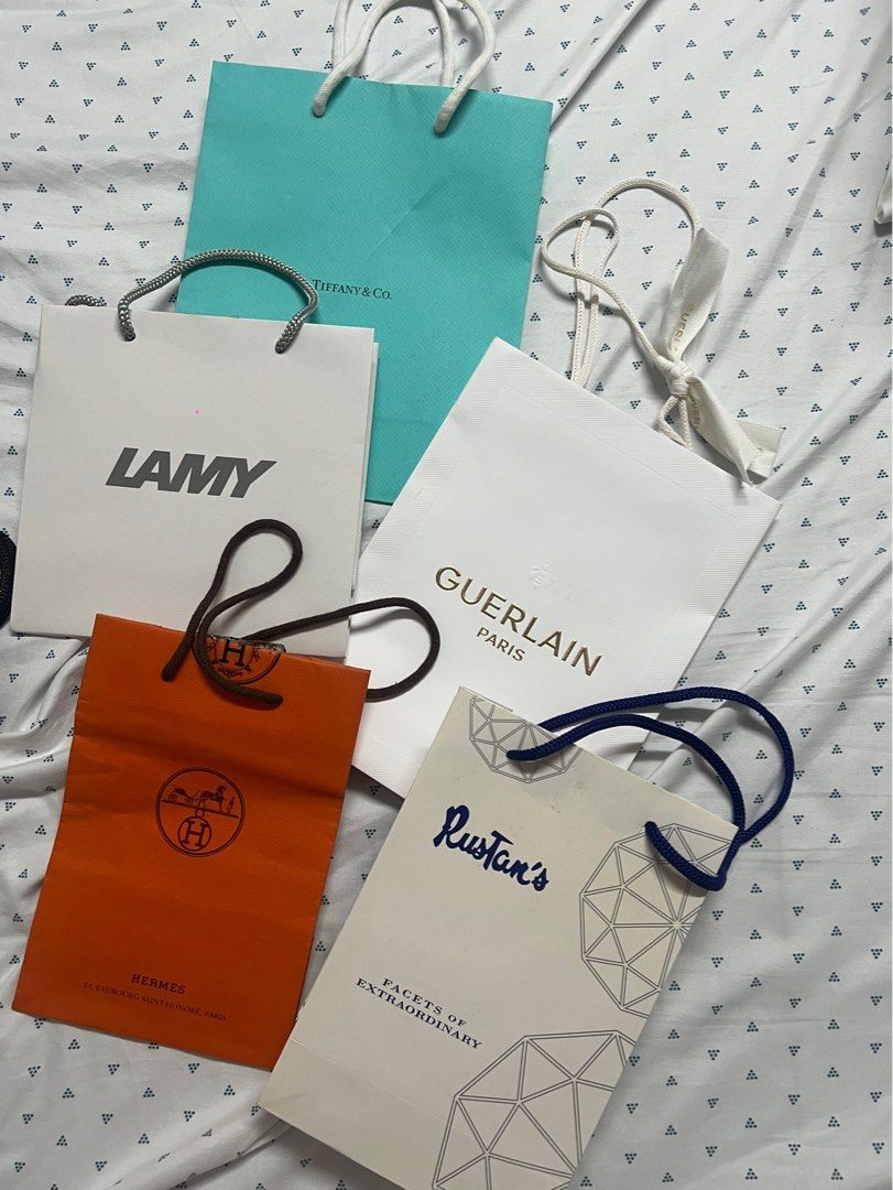 Assorted Luxury Paper Bags (Category: Luxury Bags & Wallets) located in Las Pinas. Submitted by wtscloset (Listing ID 1401120285, Image 2). Description: All legit. J&T shipping must be paid by buyer. Currently Available: 1st slide VS - 50 each Guerlain black - 50 sold chanel 85 (SOLD) cartier 500 2nd slide hermes 150 rustans 50 lamy 50 Guerlain 100 sold Tiffany 150 .