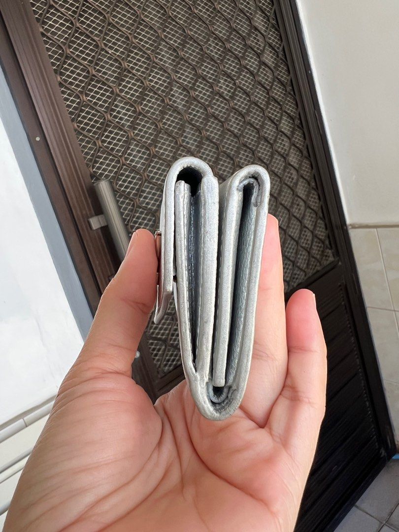 Authentic Louis Vuitton Coussin BB Silver mini lock me Wallet (Category: Luxury Bags & Wallets) located in Caloocan City. Submitted by alavishglam (Listing ID 1401110230, Image 3). Description: - Authentic Louis Vuitton Coussin BB wallet - Silver color - Snap closure - Multiple compartments - Includes original box and dust bag - Textured silver finish with LV logo - Made in Spain.