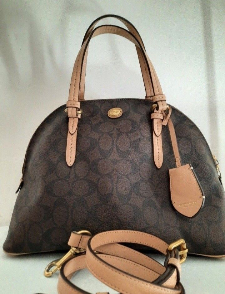 Coach Alma 2wayHandbag (Category: Luxury Bags & Wallets) located in Manila. Submitted by johnchel (Listing ID 1401019536, Image 1). Description: - Authentic Coach handbag - Spacious interior - Includes leather tag and small tag - Made of durable material - Features a neutral-colored interior lining - Includes a silica gel packet.